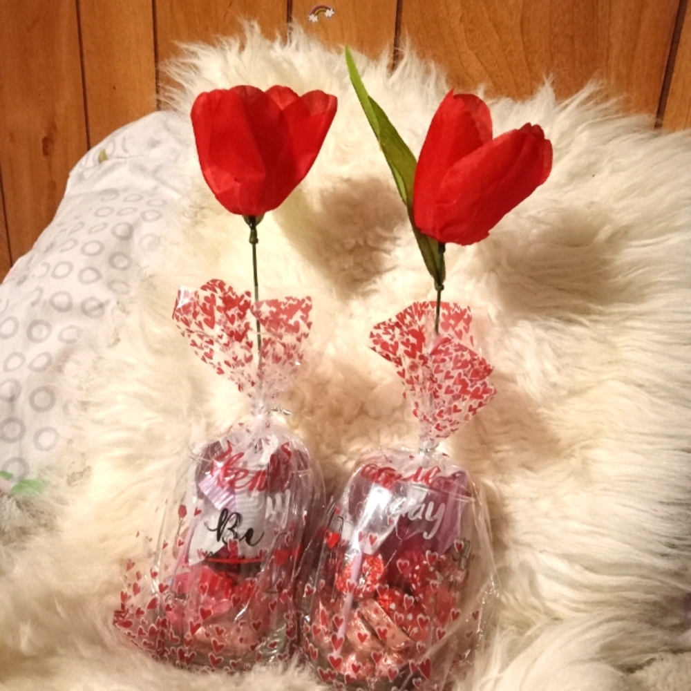 Valentine's glass with chocolate candy and rose